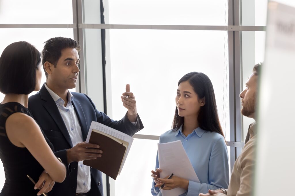 A male sales and marketing expert talking to his team